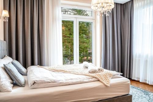 Posteľ alebo postele v izbe v ubytovaní Apartament Szymanowskiego