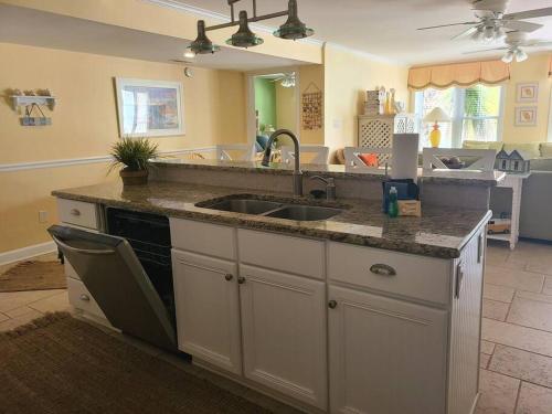 a kitchen with a sink and a counter top at Feelin' Beachy on Tybee (south beach) in Tybee Island