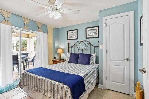 a bedroom with a bed with a blue wall at Feelin' Beachy on Tybee (south beach) in Tybee Island