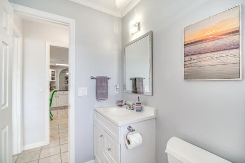 a white bathroom with a sink and a mirror at Sebastien Home with Pool and Gazebo - 8 Mi to Beaches! in Sebastian