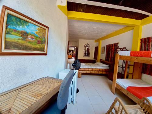 a room with two bunk beds and a room with at Hostal Las Mariposas Minca in Minca