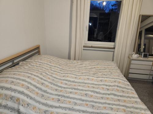 a bed in a bedroom with a window at villa high ceiling 2 bedrooms in Troisdorf