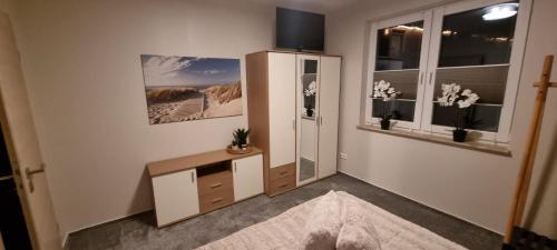 a room with a desk and a refrigerator and a window at Ferienwohnung Maasch in Vierraden