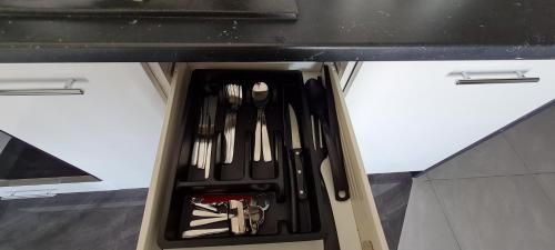 a drawer filled with utensils in a kitchen at Metro Modern Warsaw Apartments in Warsaw