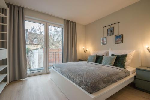 a bedroom with a bed and a large window at Wiesbaden Business Appartement in Wiesbaden