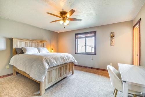 a bedroom with a bed and a ceiling fan at Rural Cody Vacation Rental about 10 Mi to Downtown! in Cody