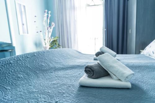 a blue bed with two towels on top of it at Pension More in Šibenik