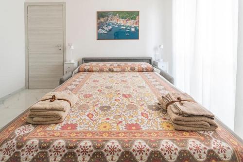 a bed in a bedroom with towels on it at Exclusive with Jacuzzi between Portofino and 5 Terre in Chiavari