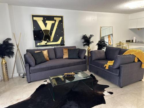 a living room with two couches and a coffee table at Zeus' Sanctuary Ocean View In Brickell Miami in Miami