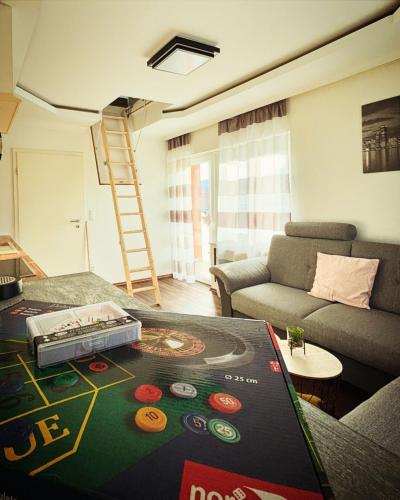 a living room with a table with a board game on it at R&S Apartment in Graz