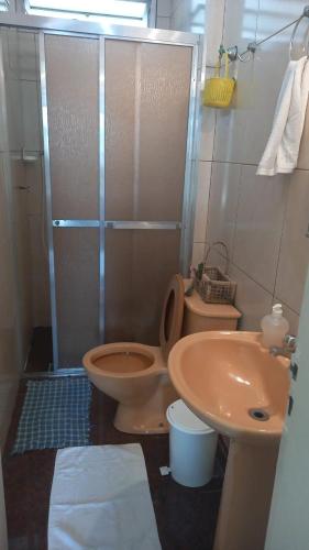 a bathroom with a shower and a toilet and a sink at Boulevard center in Guarujá