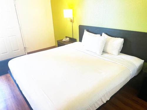 a large white bed in a hotel room at Willow Lodge Willoughby Cleveland in Willoughby