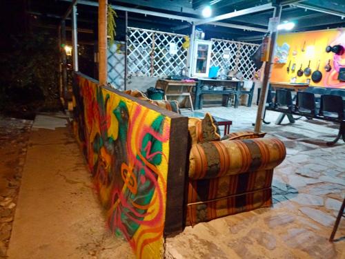 a room with a wall covered in colorful graffiti at Hostal Las Mariposas Minca in Minca