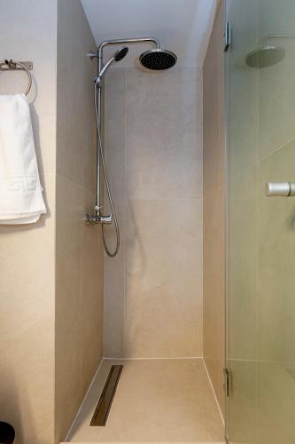 a shower with a glass door in a bathroom at Jonas port house in Agios Rokkos