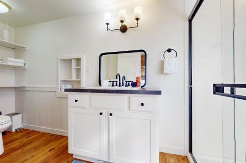 a bathroom with a sink and a mirror at Fountain District Bungalow in Bellingham