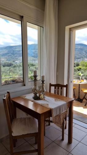 a dining room with a table and a window at Chania Homely Apartments in Souda