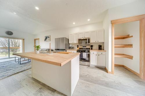 a kitchen with white cabinets and a wooden counter top at 4 Mi to Lake Erie Condo with Golf Course Views! in Erie