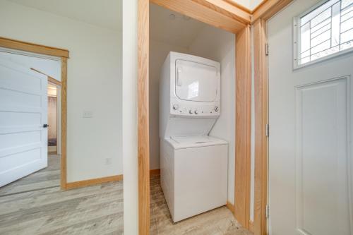 a laundry room with a washer and dryer next to a door at Erie Vacation Rental with Patio, Near Golf Course! in Erie