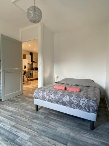 a bedroom with a bed and a living room at Verger - Parking gratuit - Calme in Chambéry