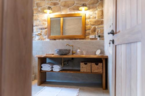 a bathroom with a sink and a mirror at Guest Accommodation Butina in Kuterevo