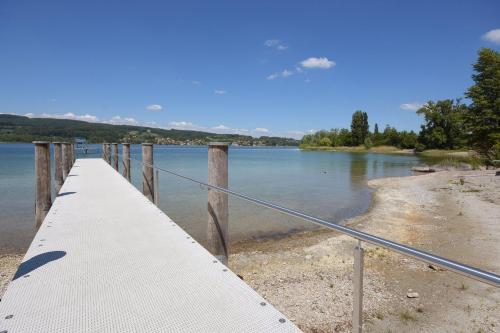 a bridge over a body of water at Strandbad Steckborn mit Herberge, Camping & Glamping in Steckborn