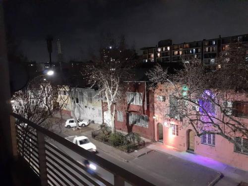 a view from a balcony of a building at night at Departamento Estudio acogedor in Santiago