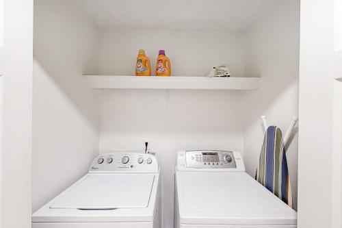 a kitchen with two white appliances and two shelves at A Peaceful Place in Kennesaw