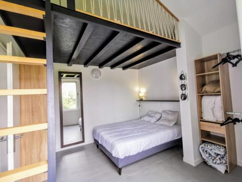 a bedroom with a bed and a bunk room at Sea Sun and Thau in Marseillan