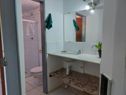 a bathroom with a sink and a toilet and a mirror at Espaço Circular in Itacaré