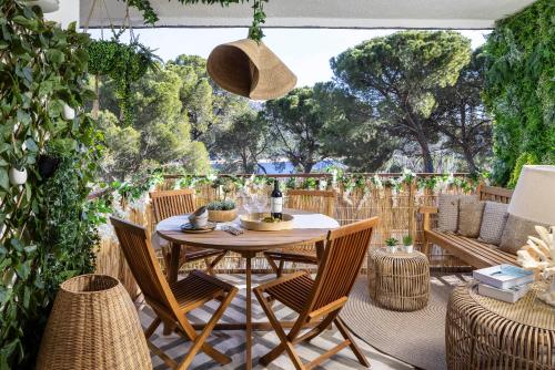 a patio with a table and chairs and trees at Costa De Madrid-San Martin de Valdeiglecias in San Martín de Valdeiglesias