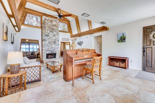 a living room with a piano and a couch at Unique Melrose Home with Private Dock and Lake Access! in Keystone Heights
