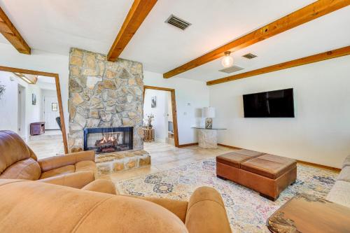 a living room with a couch and a fireplace at Unique Melrose Home with Private Dock and Lake Access! in Keystone Heights