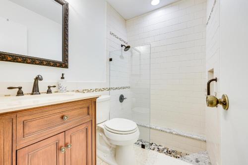 a bathroom with a toilet and a sink and a shower at Unique Melrose Home with Private Dock and Lake Access! in Keystone Heights