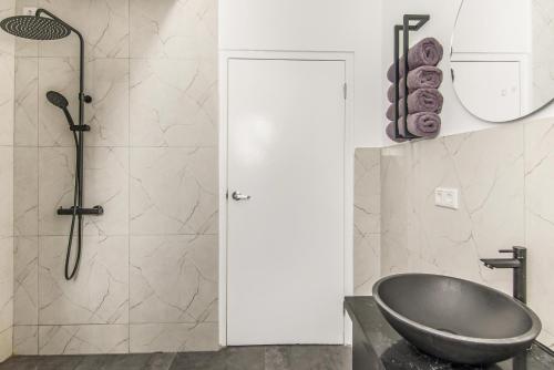 a bathroom with a sink and a shower at Modern 3-Bed Apartment in Papaya Resort in Grote Berg