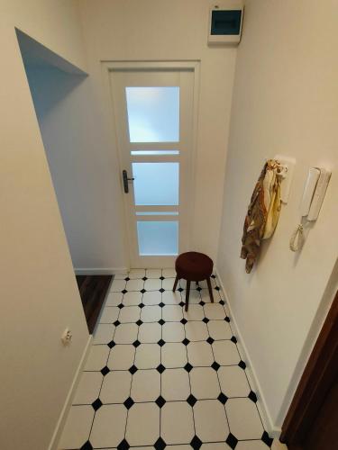 a stairway with a door and a stool in a room at Apartament Inka in Gollnow
