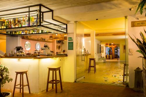 a bar in a room with stools at Hotel Barahona Cartagena in Cartagena de Indias