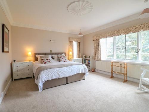 a bedroom with a large bed and a window at The Lodge in Grantham