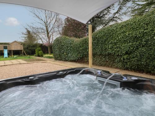 a hot tub with water coming out of it at The Lodge in Grantham