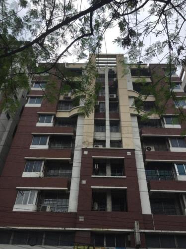 a tall brick building with many windows at Rainbow Guest House in Dhaka