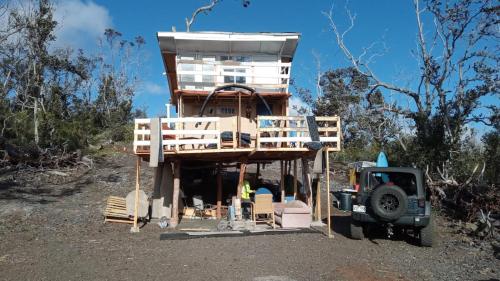 a tree house being constructed with a truck in front at Bring Your Camp in Hawaiian Ocean View