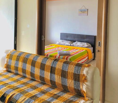 a bedroom with a bed and a couch in it at Pd Infront Seaview in Port Dickson
