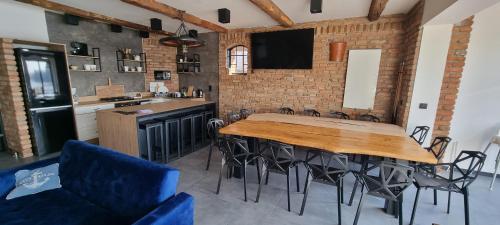a kitchen with a table and chairs in a room at Rybacka Osada in Piecki