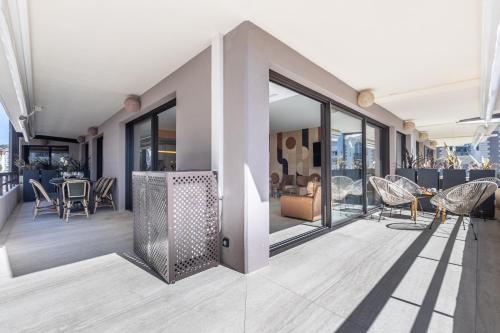 - un accès au balcon d'un immeuble avec des chaises et des tables dans l'établissement LB Vacation Rentals I A short Stroll to Palais, Beach, Terrace & Seaview, à Cannes
