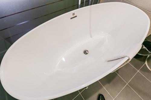 a white toilet with the lid up in a bathroom at Sejong City Osong Hotel in Cheongju