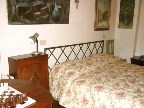 a bedroom with a bed and a table with a chess board at La Residence da Caterina in Vittorio Veneto