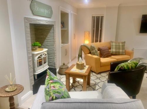 a living room with a couch and a fireplace at Ivy Lane in Loughanure