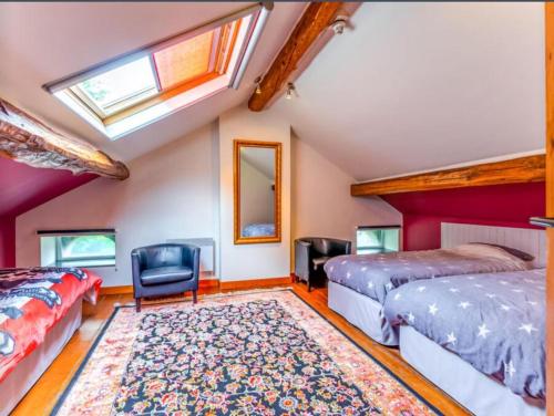 a bedroom with two beds and a window at 6 bedrooms mansion with sauna enclosed garden and wifi at Aywaille in Aywaille
