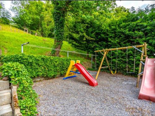 a playground with a slide and a swing at Spacious castle with garden in Aywaille in Aywaille