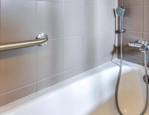 a shower in a bathroom with a white tub at Spacious castle with garden in Aywaille in Aywaille