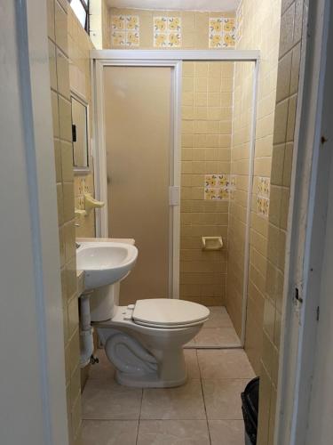 a bathroom with a toilet and a sink at Hotel Cupules in Mérida